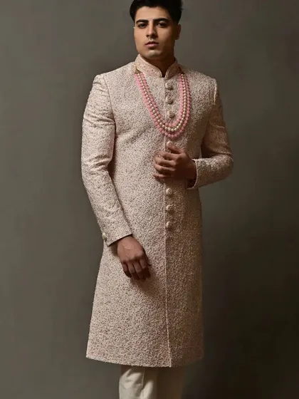 The full-length view of this sophisticated pink sherwani, a perfect choice for the modern groom.