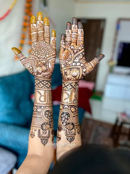 Another view of the personalized bridal mehendi for Rasika, showing how the custom portraits and initials are integrated seamlessly into the traditional design elements like peacocks and paisleys.