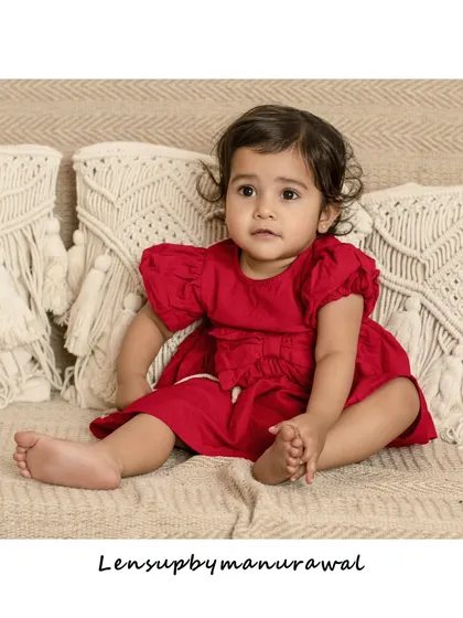 A quiet, thoughtful moment from a toddler session. Dressed in a lovely red dress, she sits calmly, allowing me to capture her natural curiosity and beautiful features.