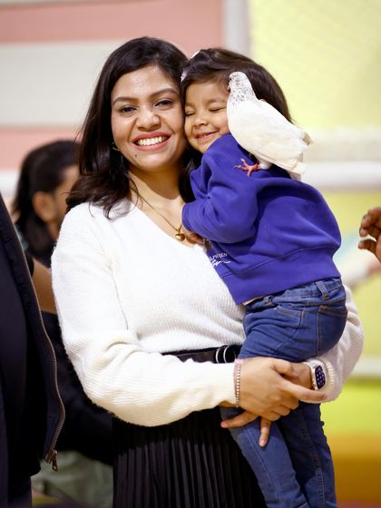 A mother and daughter share a sweet hug with a magical dove. Our gentle animal encounters are a heartwarming addition to any party.