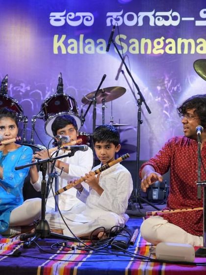 Our guru actively conducting his students during the bansuri performance, ensuring a cohesive and beautiful rendition.