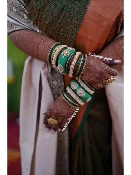 The rich, dark stain of a bridal mehndi, beautifully accessorized with green bangles. This is the kind of result I aim for with every bride.