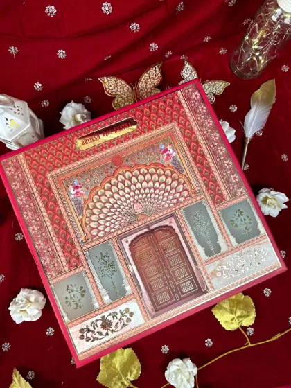 A flatlay of the Jaipur-inspired card, showing how the rich red and intricate gold details create an unforgettable first impression.