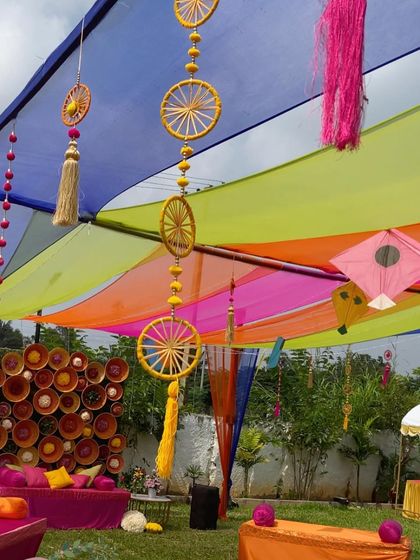 A closer look at the colorful draped ceiling and the whimsical hanging decorations like kites and tassels.
