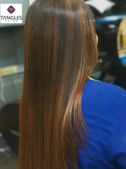 A side view showcasing the seamless blend of the balayage color and the sleek finish from the hair botox. This combination is perfect for a polished yet modern look.