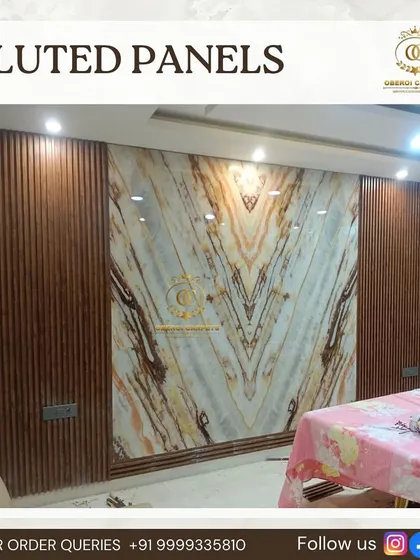 A dining area gets a major upgrade with our fluted panels framing a large, book-matched UV marble sheet, creating a luxurious and impressive feature wall.