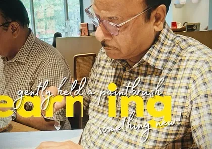 Hands that once held their daughters as children now gently hold a paintbrush, learning something new. It's never too late to start a creative journey.