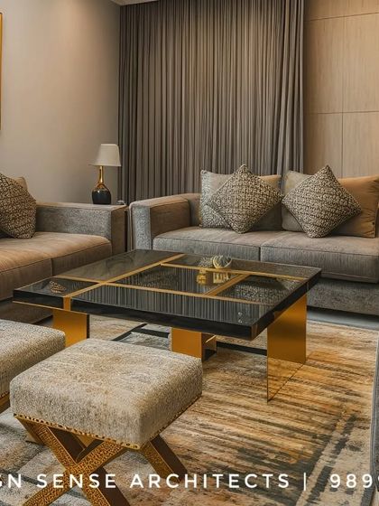 A sophisticated living room in Rohini, where we used a neutral color palette with gold and black accents. The black marble coffee table with a gold base adds a touch of modern luxury.