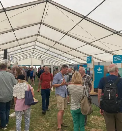 A bustling scene inside the exhibition tent at the Global Birdfair. We are proud to be a part of this vibrant international event that brings together the world's birding community.