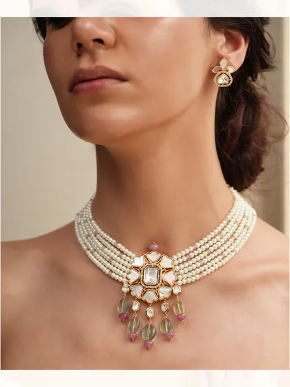 A classic pearl choker with a central polki pendant and delicate colored bead drops, embodying timeless elegance.