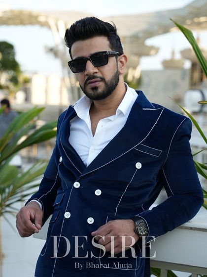 A close-up portrait in the blue velvet blazer, showcasing its luxurious texture and the powerful presence it commands.