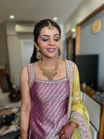 A beautiful, fresh makeup look for a wedding guest. The eyes have a hint of purple shimmer, and the skin is glowing and flawless.