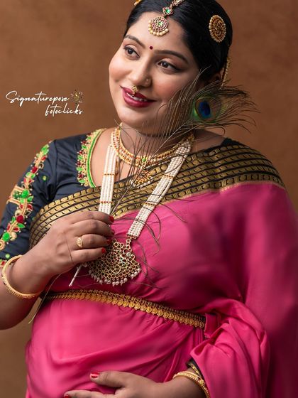 The peacock feather adds a symbolic touch of grace and royalty to this beautiful traditional portrait.