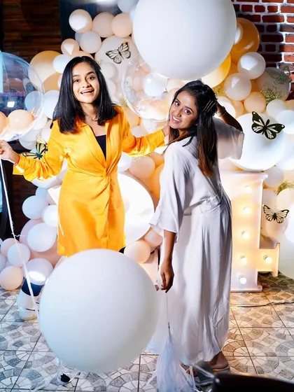 Happy faces and fun poses at this birthday celebration. The balloon wall with butterfly accents was a huge hit.
