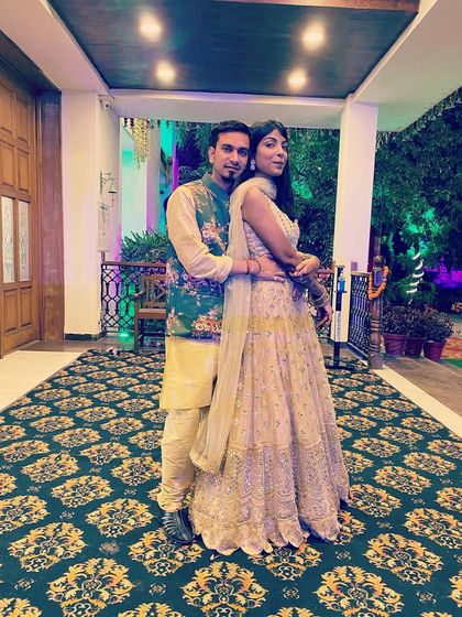 A photo with my husband, where I'm wearing a beautiful embroidered lehenga. This is a classic, elegant choice for any wedding function. I help my clients find timeless pieces they will love for years.