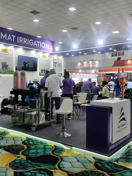 Another angle of our exhibition stall, showing our team engaged with visitors. We display a range of products, from large filtration units to smaller sprinkler components.