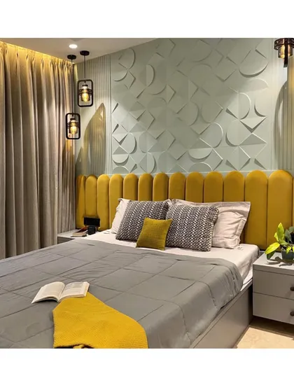 A bold and beautiful bedroom design featuring a mustard yellow velvet headboard set against a mint green 3D-paneled wall. The contrasting colors and textures create a vibrant and modern look.