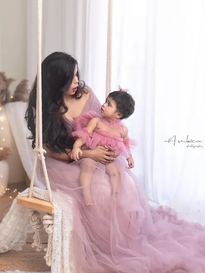 A candid moment on the studio swing. The mother looks at her daughter with so much love, a beautiful interaction captured forever.