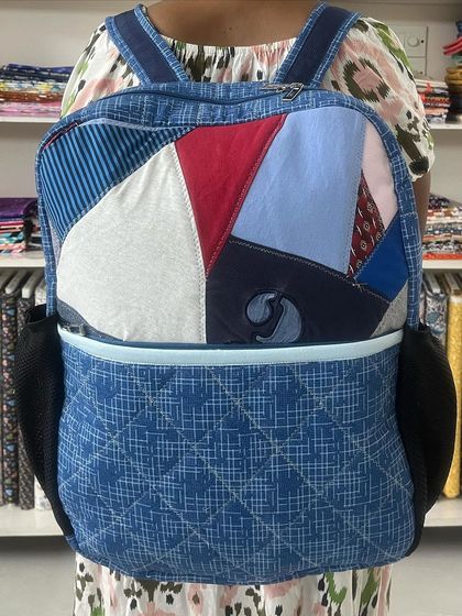 This custom backpack was upcycled from old t-shirts and shirts, featuring a patchwork design and a separate laptop compartment.