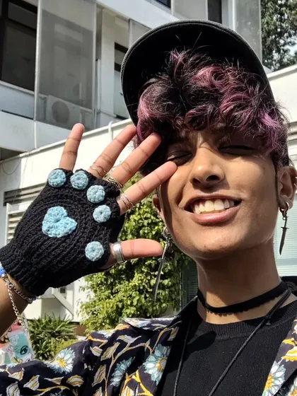 Here I am modeling one of my favorite wearable crochet pieces, the cat paw fingerless gloves. They're super cute and practical, showing how my art can be both fun and functional.