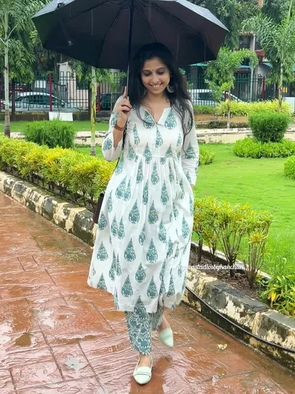 A rainy day doesn't have to be dull. This white and green printed kurta-pant set brings a touch of freshness and style.