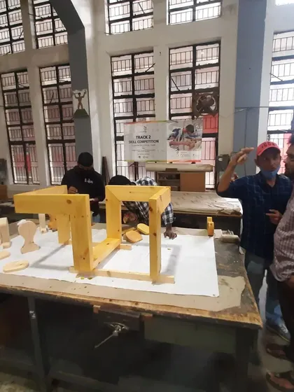 An instructor discusses the progress of a project with a student during the finishing stage.