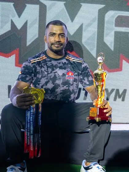 Our wrestling coach, Ravi Jadhav, with his well-earned medals and the team trophy. His contribution to our grappling game is immense.