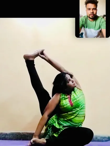 This is a snapshot from a live online class, where I am guiding a student through an advanced leg and hip opening pose. Even in a virtual setting, I provide personalized attention to help you achieve correct alignment and deepen your stretches safely.