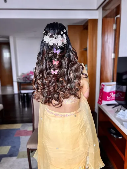 Another view of this dreamy haldi hairstyle, showing the colorful butterfly accessories.