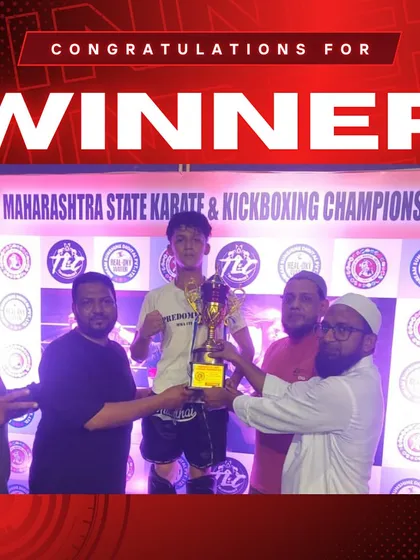 A young fighter holding his trophy high. Our training prepares athletes for the podium.