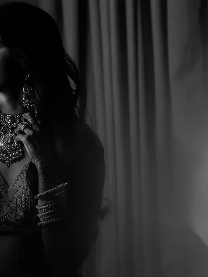 A beautiful black and white portrait of Ipsa by the window. The soft light and her serene expression create a timeless and soulful image that is full of grace.
