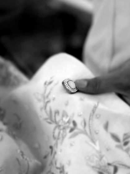 The final touches are everything. Placing a custom, jewel-encrusted button is a small but critical step in creating a garment that is truly one of a kind.