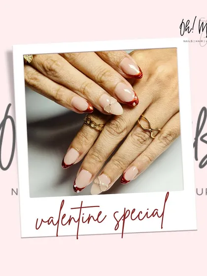 Love is in the nails. This Valentine's special features a deep red French tip, accented with delicate 3D bows and tiny pearl details for a romantic touch.