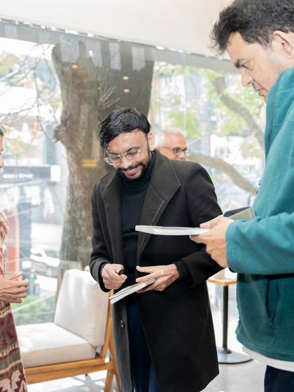 Author Mini Menon in conversation with attendees during the book signing portion of her launch event.