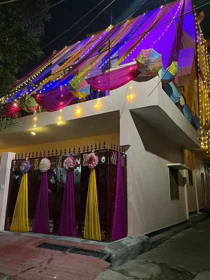 The vibrant colors of the drapes are beautifully illuminated by the lights at night.