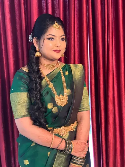 A happy bride at her engagement ceremony. Her hair is styled in a simple side braid, a classic and elegant choice that is both beautiful and practical.