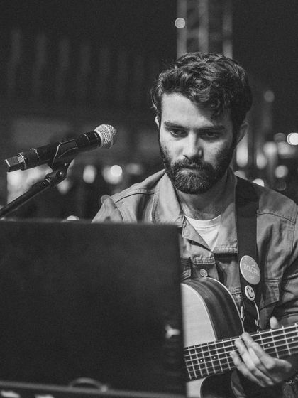 Focused on the music. A monochrome shot of me at the guitar, getting ready for the next chord.