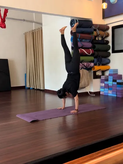 My practice extends beyond the hammock. Mat-based exercises like this handstand are crucial for developing the strength and balance that support our work in the air.