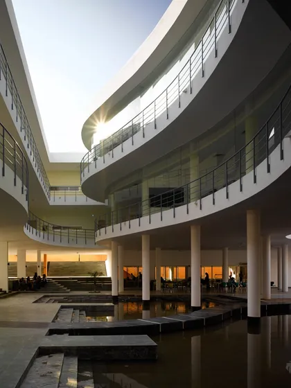 The Pearl Academy in Jaipur is a testament to our climate-responsive design approach. The central courtyard, inspired by traditional Indian step-wells or 'baolis', acts as a natural thermal regulator, using evaporative cooling from the water body to create a comfortable microclimate in the desert heat.