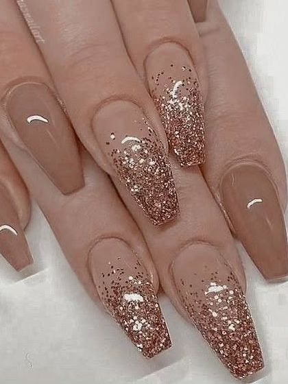 A classic and elegant glitter ombre. This design features a beautiful rose gold glitter fading into a warm nude base on long, coffin-shaped nails.