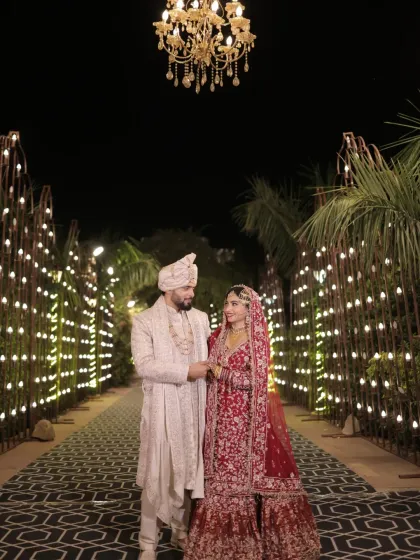 A beautiful portrait of the newly married couple under a stunning chandelier. This shot combines grand decor with a tender moment between the two.
