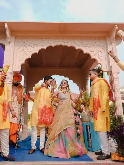 The energy of a Haldi ceremony is infectious. Here, the bride and groom make a grand entrance surrounded by their loved ones, ready for a celebration full of color and laughter.