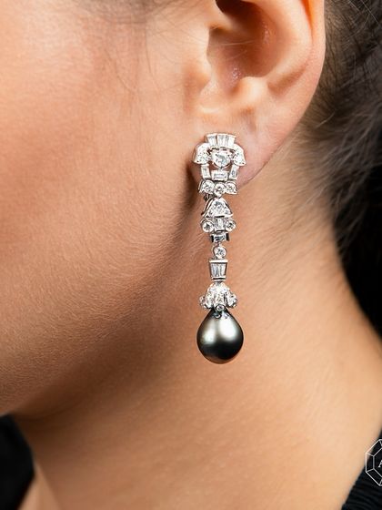 These Long Drop Pearl and Diamond Earrings offer irresistible elegance, letting your luxury shine through every occasion.
