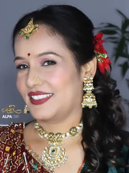 A happy client in her 40s, ready for a wedding function. I gave her a classic look with a bold red lip, soft shimmery eyes, and traditional jewelry.