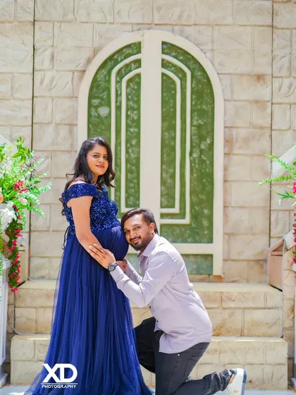 A sweet moment with the father-to-be listening to the baby bump in front of a beautiful stone archway.