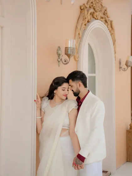I focus on the quiet connection between two people. This intimate portrait, taken at an elegant architectural location, showcases a soft, romantic style, proving that the most powerful photos are often the most gentle.