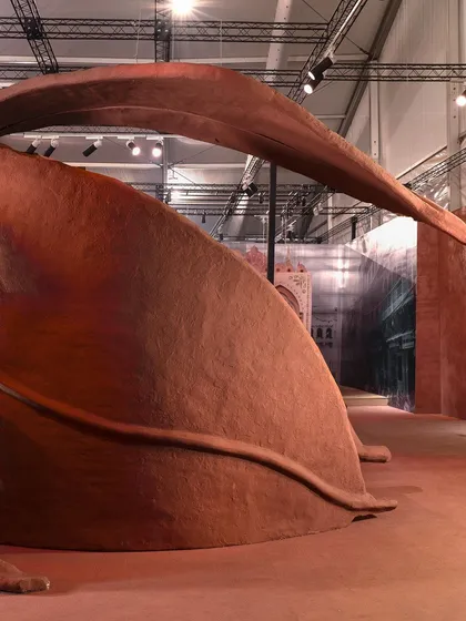 A low-angle view of the 'Terra' installation, emphasizing the upward sweep of the leaf forms. The piece feels both grounded and aspirational, rooted in the earth but reaching for the sky.