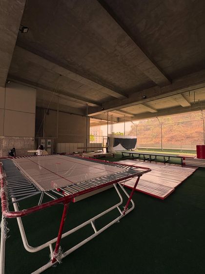 A glimpse of our gymnastics setup, including the long trampoline used for practicing tumbling passes.