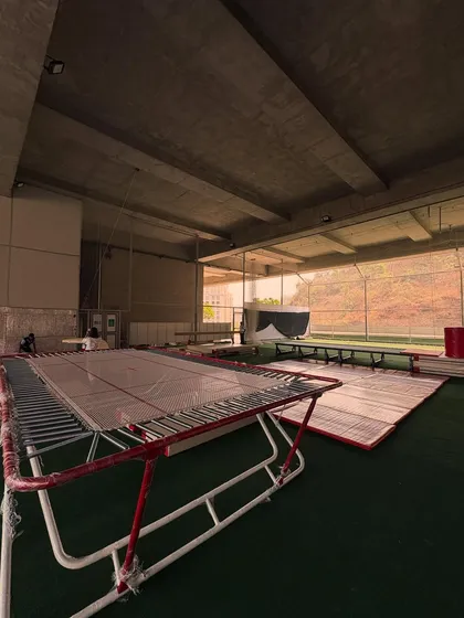 A view of the gymnastics setup, featuring trampolines and mats ready for action. This shows the professional equipment and spacious layout I provide for our gymnasts.