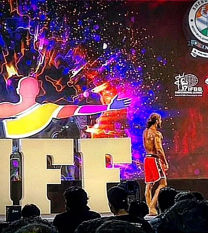 Another angle from the IHFF stage. Notice the stage presence and posing. It's not just about muscle; it's about how you present your physique to the judges.